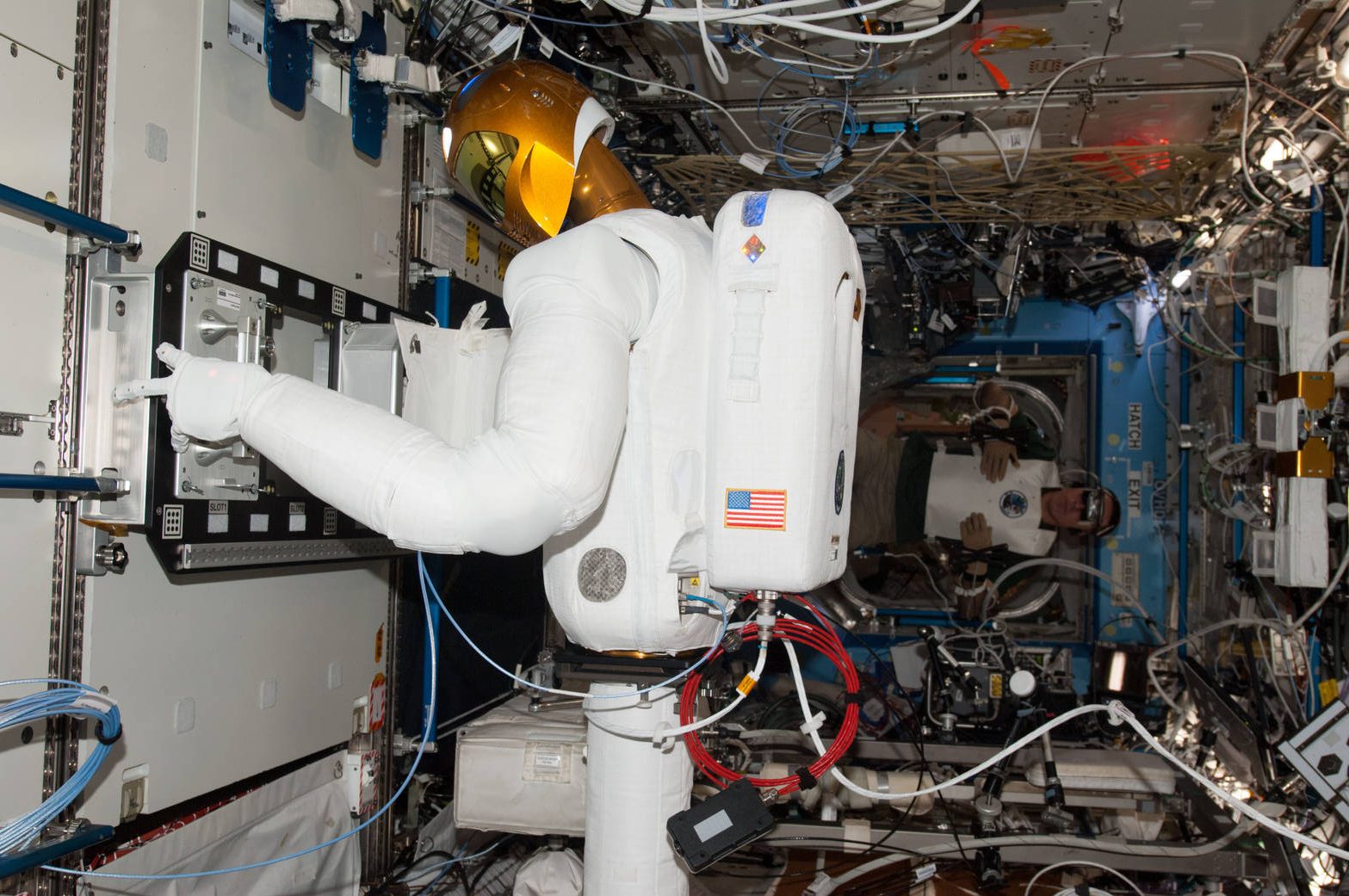 Astronaut Chris Cassidy demonstrates control of NASA Robonaut 2 in 2013.